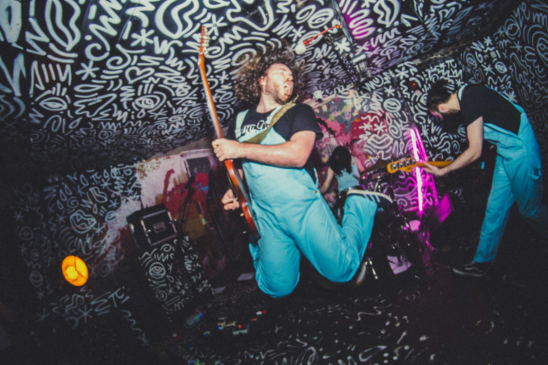 Concert performer mid-jump during a live music set