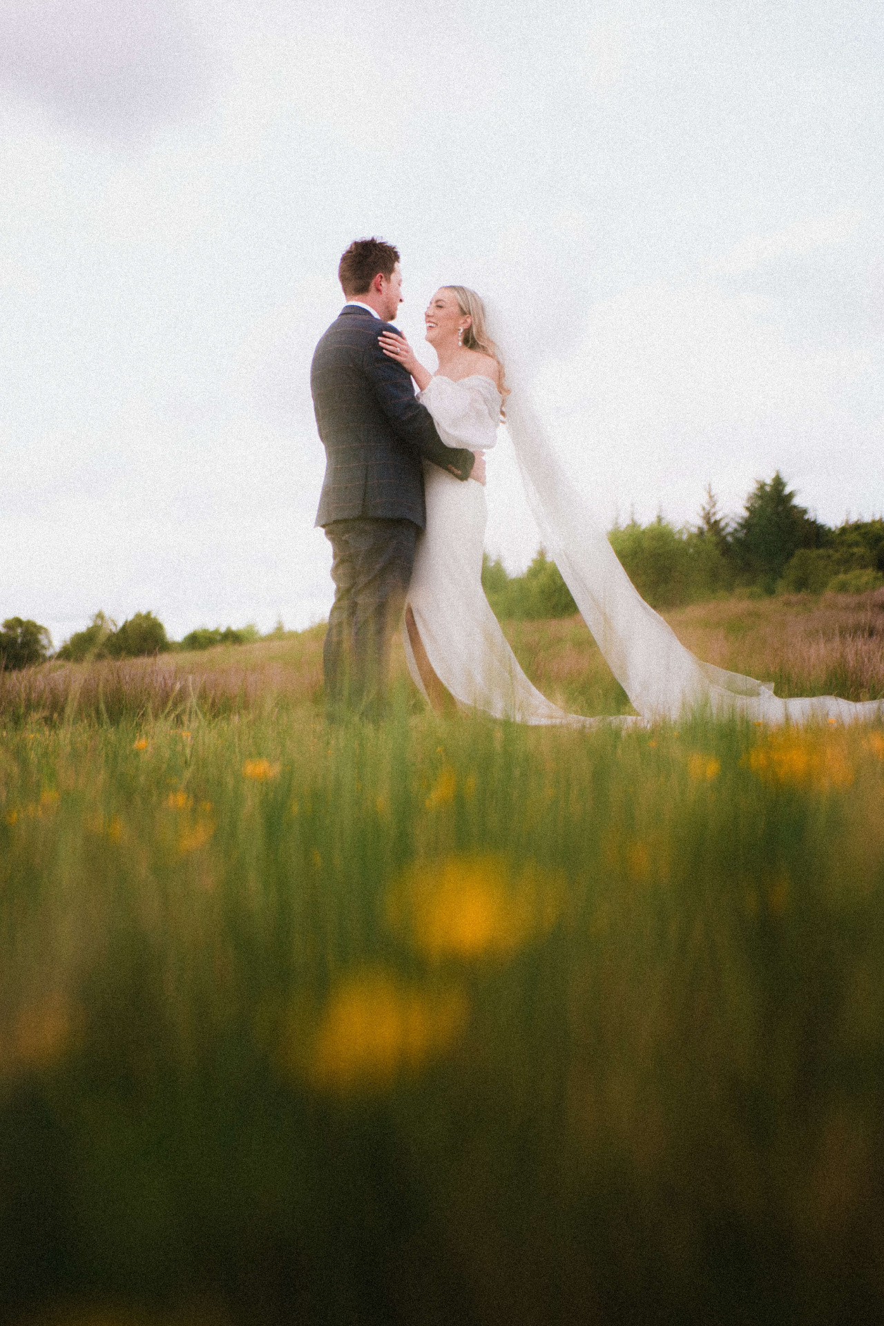 Couple walking through a sunlit field
