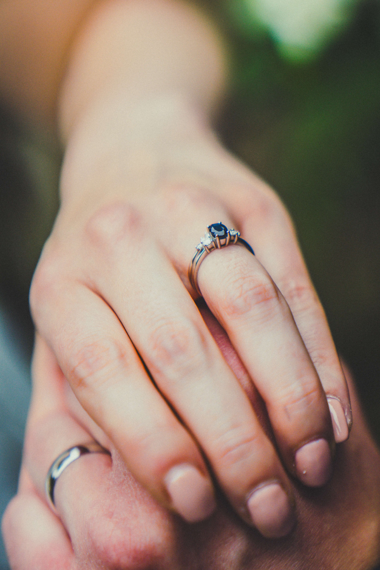 Wedding rings detail shot on textured surface