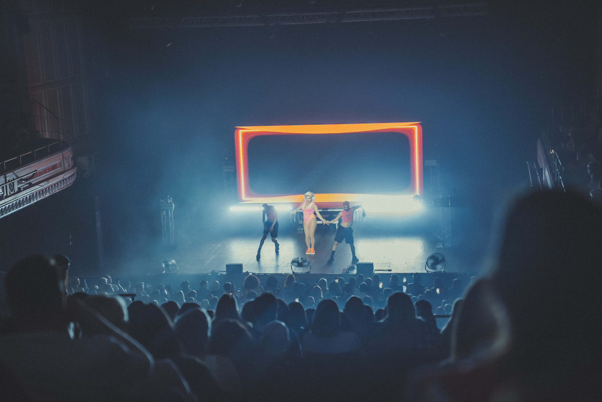 Live band performing on stage under coloured lighting