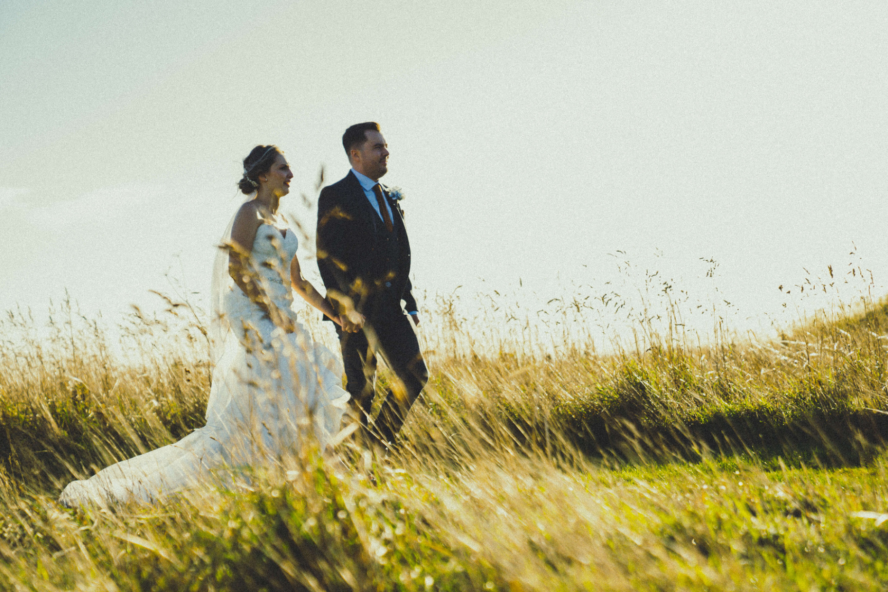 Wedding couple embracing in an open Northumberland field